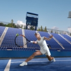 Tennis player reaching for a backhand